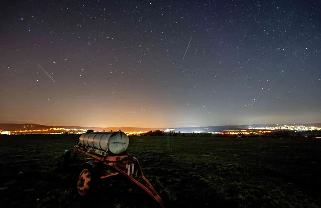 Long exposure photo shows a water tank on a cow meadow in the Taurus region near Frankfurt, Germany, as the stars shine on early Tuesday, February 28, 2023. (Photo by Michael Probst/AP Photo)