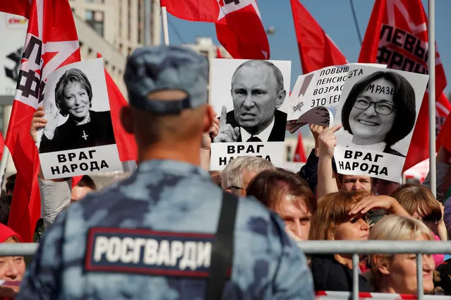 Supporters of left-wing political parties and movements hold placards depicting Russian Federation Council Speaker Valentina Matviyenko, President Vladimir Putin and Central Bank Governor Elvira Nabiullina during a rally against the pension reform, which envisage raising the retirement age, in Moscow, Russia on September 22, 2018. (Photo by Maxim Shemetov/Reuters)