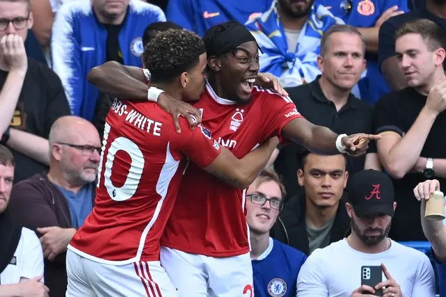 Nottingham Forest's Swedish midfielder #21 Anthony Elanga (R) celebrates with Nottingham Forest's English midfielder #10 Morgan Gibbs-White (L) after scoring the opening goal during the English Premier League football match between Chelsea and Nottingham Forest at Stamford Bridge in London on September 2, 2023. (Photo by Justin Tallis/AFP Photo)