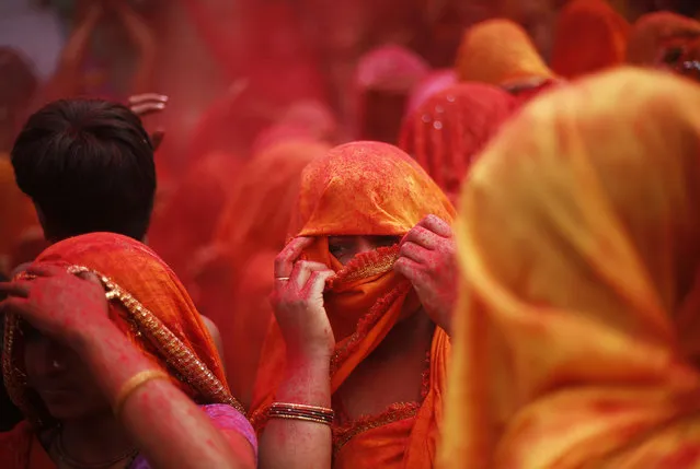A woman covers her face as she takes part in “Huranga” at the Dauji temple near the northern Indian city of Mathura, March 7, 2015. (Photo by Adnan Abidi/Reuters)
