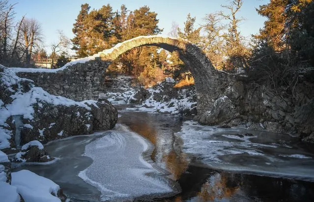 The River Dulnain is seen partially frozen under the old pack horse bridge on February 11, 2021 in Carrbridge, United Kingdom. The village of Carrbridge in Badenoch and Strathspey in the Scottish Highlands recorded –18 degrees celsius this morning. Braemar, Aberdeenshire, recorded –22.9 degrees celsius overnight, making it the coldest night on record there since 1986. Record levels of snow have fallen in Braemar in what the Met Office are calling the Big Freeze in the aftermath of Storm Darcy. (Photo by Peter Summers/Getty Images)