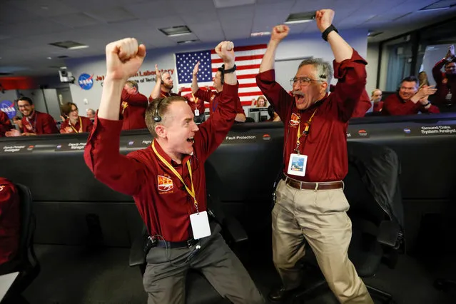 NASA engineers Kris Bruvold (L) and Sandy Krasner (R) react after the successful landing by the InSight spacecraft on the planet Mars from the Mission Support area in the Space Flight Operations facility at the NASA Jet Propulsion Laboratory (JPL) in Pasadena, California on November 26, 2018. Cheers and applause erupted at NASA' s Jet Propulsion Laboratory as a $993 million unmanned lander, called InSight, touched down on the Red Planet and managed to send back its first picture. (Photo by Al Seib/Pool via Reuters)
