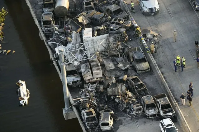 In this aerial photo, responders are seen near wreckage in the aftermath of a multi-vehicle pileup on I-55 in Manchac, La., Monday, October 23, 2023. A “superfog” of smoke from south Louisiana marsh fires and dense morning fog caused multiple traffic crashes involving scores of cars. (Photo by Gerald Herbert/AP Photo)