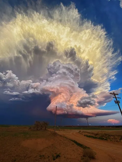 A remarkable image of a storm gathering over a sunset is captured in the open road between the cities of Earth and Littlefield in Texas in May 2021. (Photo by Laura Rowe/The Times)
