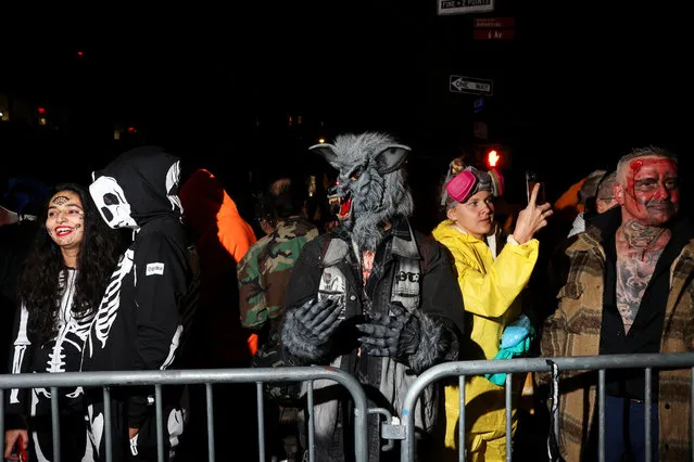 People wait for the 50th annual NYC Halloween Parade to start in New York City, U.S., October 31, 2023. (Photo by Caitlin Ochs/Reuters)