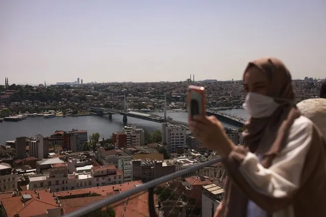 A woman takes photos, in Istanbul, Thursday, July 1, 2021. (Photo by Emrah Gurel/AP Photo)