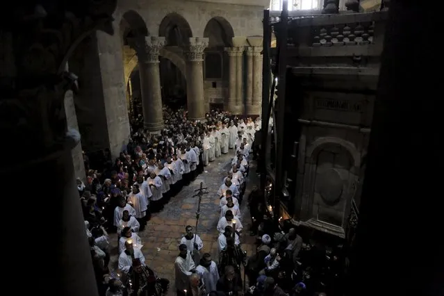 Members of the Catholic clergy and Christian worshippers hold candles during Easter procession in the Church of the Holy Sepulchre in Jerusalem's Old City April 5, 2015. (Photo by Ammar Awad/Reuters)