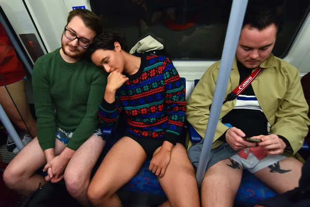 People take part in the annual “No Trousers On The Tube Day” (No Pants Subway Ride) on the London Underground Jubilee Line, posing for photographs at Canary Wharf, in London on January 13, 2019. (Photo by Alberto Pezzali/NurPhoto via Getty Images)