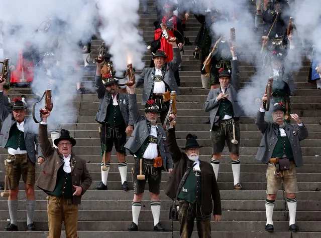 Traditionally dressed Bavarians shoot salute on the stairs of the Bavaria statue on the last day of the 187th Oktoberfest in Munich, Germany on October 3, 2022. (Photo by Michaela Rehle/Reuters)