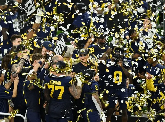 Michigan Wolverines head coach Jim Harbaugh holds the National Championship Trophy as he celebrates after winning 2024 College Football Playoff national championship game against the Washington Huskies at NRG Stadium in Houston, TX on January 8, 2024. (Photo by Maria Lysaker/USA TODAY Sports)