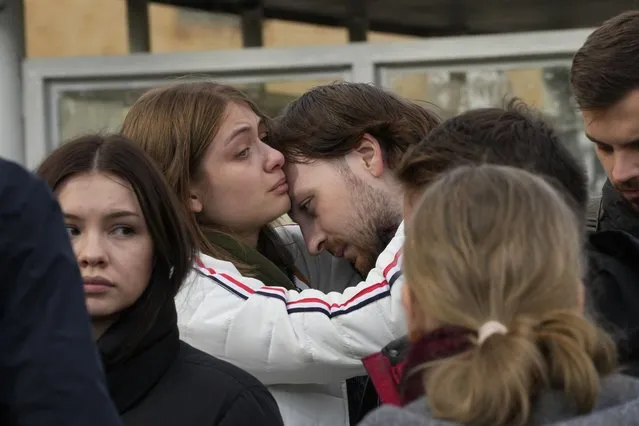 Students comfort each other as they gather outside the Perm State University following a campus shooting in Perm, about 1,100 kilometers (700 miles) east of Moscow, Russia, Tuesday, September 21, 2021. (Photo by Dmitri Lovetsky/AP Photo)