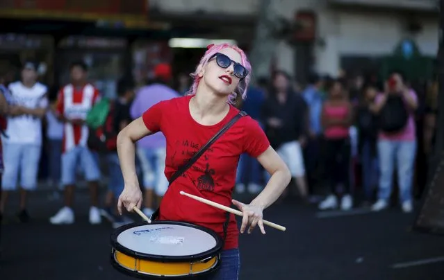 A woman beats a drum during a demonstration to mark International Women's Day and to demand policies to prevent femicides outside the Congress in Buenos Aires, Argentina, March 8, 2016. (Photo by Marcos Brindicci/Reuters)