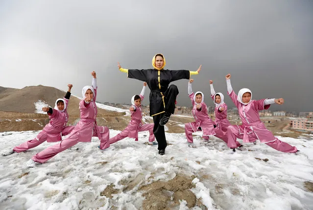 Sima Azimi (C), 20, a trainer at the Shaolin Wushu club, poses with her students after an exercise on a hilltop in Kabul, Afghanistan January 29, 2017. (Photo by Mohammad Ismail/Reuters)