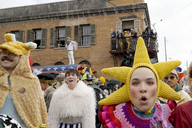 People walk in costumes during the Society of Saint Anne parade through Bywater and Marigny neighborhoods on Mardi Gras Day in New Orleans, Tuesday, February 13, 2024. (Photo by Matthew Hinton/AP Photo)