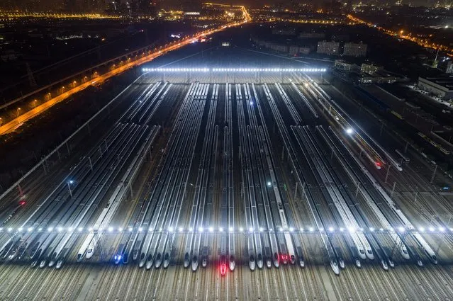 High speed trains are lined up after undergoing maintenance in preparation for the annual Lunar New Year travel peak, at a maintenance base in Wuhan, in China’s central Hubei province early on January 26, 2024. (Photo by AFP Photo/China Stringer Network)