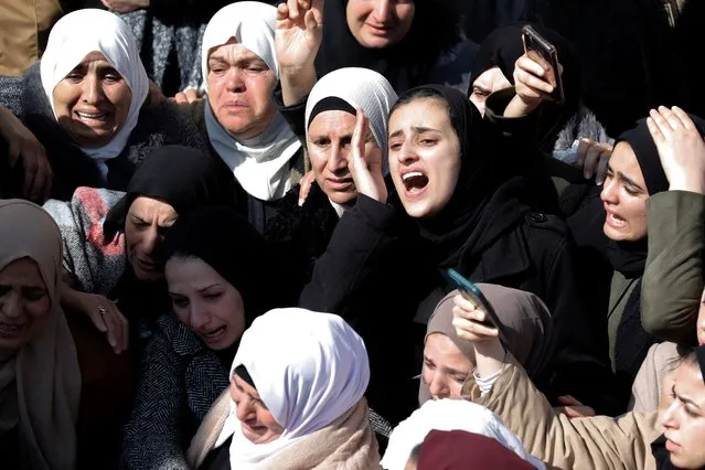 Palestinian women mourn during the funeral procession of Anas Dweikat, 26, in the West Bank town of Rujayb, east of Nablus, on February 19, 2024, after he was shot dead by Israeli forces the previous day at the nearby Beit Furik checkpoint. The Israeli military said on February 18 that it had shot a suspect outside the city of Nablus who approached soldiers after getting out of a vehicle. The Palestinian Fatah movement said the man, a security officer, was “assassinated in cold blood” at the checkpoint as the Israeli forces have stepped up their near daily raids across the occupied West Bank in the aftermath of Hamas's October 7 attack on southern Israel. (Photo by Zain Jaafar/AFP Photo)