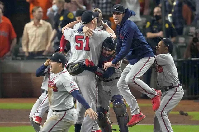 The Atlanta Braves celebrate after winning baseball's World Series in Game 6 against the Houston Astros Tuesday, November 2, 2021, in Houston. The Braves won 7-0. (Photo by Sue Ogrocki/AP Photo)