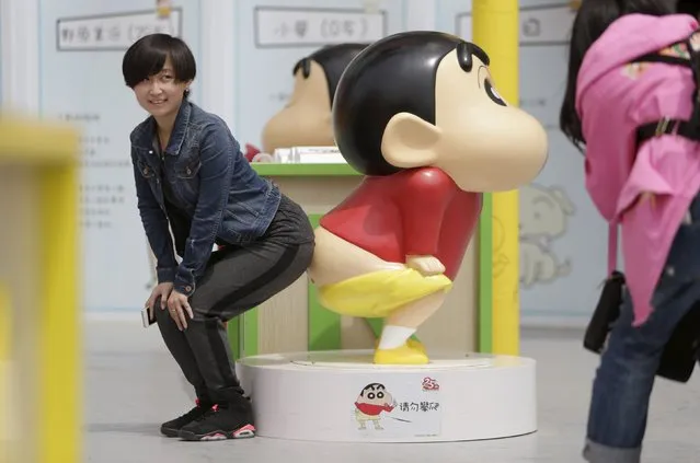 A visitor poses for a photo with a Crayon Shin-chan model during an exhibition at Joy City in Beijing May 5, 2015. (Photo by Jason Lee/Reuters)