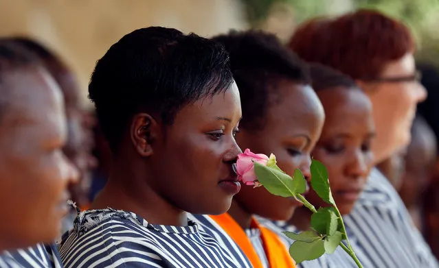 A female inmate smells a rose flower intended for Valentine's Day, during a celebration dubbed “love behind bars” inside the Langata Women Maximum Security Prison in Kenya's capital Nairobi, February 14, 2017. (Photo by Thomas Mukoya/Reuters)