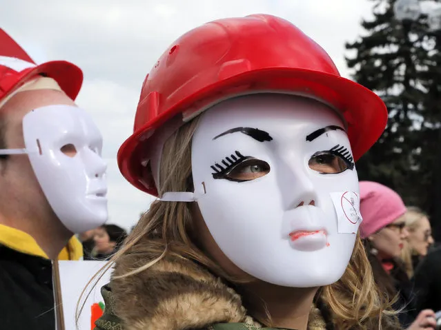 Masked s*x workers hold a rally in front of the Ukrainian Parliament building in Kiev, Ukraine, Friday, March 3, 2017. The rally was held to demand the legalisation of their work. (Photo by Efrem Lukatsky/AP Photo)