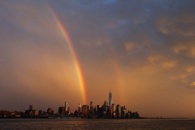 A double rainbow appears at sunset over lower Manhattan following a rain storm, June 5, 2016, in New York. (Photo by Gary Hershorn/Getty Images)