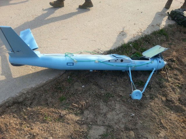 This picture released on April 2, 2014 shows wreckage of a crashed drone found on March 31, 2014 at Baengnyeong island near the disputed waters of the Yellow Sea. South Korea said it had recovered an unidentified drone that crashed on one of its border islands the same day that North and South Korea exchanged artillery fire across their disputed maritime boundary. (Photo by AFP Photo/South Korean Defence Ministry)