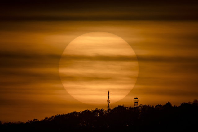 The Sun sets behind Mount Karancs near Salgotarjan, northern Hungary, 13 April 2024 (Issued on 14 April 2024). (Photo by Peter Komka/EPA)