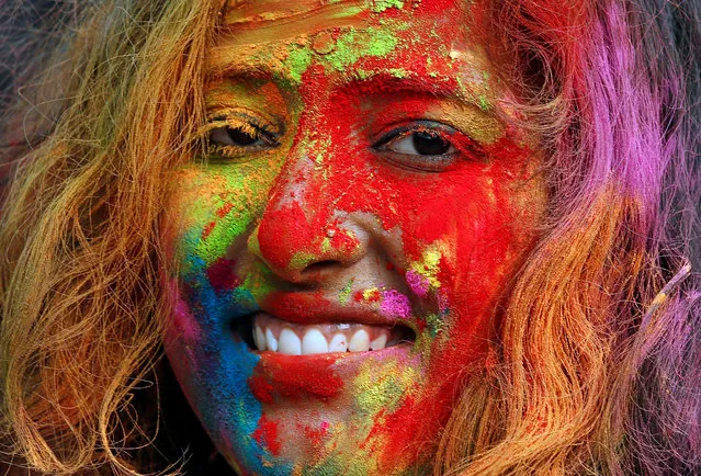 A student of Rabindra Bharati University, with her face smeared in coloured powder, is seen during Holi celebrations inside the university campus in Kolkata, India. (Photo by Rupak De Chowdhuri/Reuters)