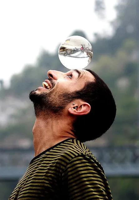 “Crystal ball”. In the ball of this street performer, one can see the D.Luis bridge in Oporto, city considered the best European destination 2014. Photo location: Oporto, Portugal . (Photo and caption by Luis Moreira/National Geographic Photo Contest)