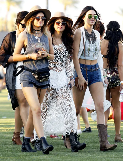 Selena Gomez is joined by Kendall and Kylie Jenner on day one of week one at The Coachella Music Festival in Indio. Indio, California, on Friday, April 11, 2014. Gomez wore a a white lace dress, Kylie wore a David Bowie shirt, jean shorts and a hat, while Kendall wore a crop top, denim shorts and a floral waistcoat. Selena was seen taking a break sitting in the field enjoying a slice of pizza. (Photo by Dome/Jones/PacificCoastNews)