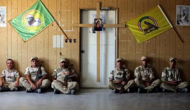 Iraqi Christians volunteers, who have joined Hashid Shaabi (Popular Mobilization), allied with Iraqi forces against the Islamic State, rest during training in a military camp in Baghdad, July 1, 2015. (Photo by Reuters/Stringer)