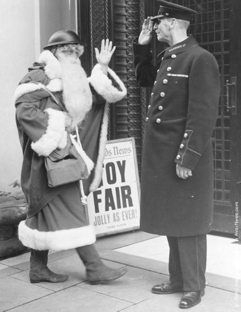 1939: Even Father Christmas follows the war time safety precautions as he arrives this year, complete with tin helmet, at London's famous Brompton road store, Harrods