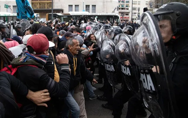 Photo released by Noticias Argentinas of protesters clashing with riot police outside the Social Development Ministry building in Buenos Aires on September 11, 2019. Social organizations set up an overnight camp in front of the ministry's building to call on the government to declare a food emergency. (Photo by Damian Dopacio/Noticias Argentinas/AFP Photo)