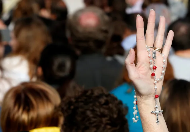 A faithful holds a rosary as she attends the Easter mass led by Pope Francis in Saint Peter's Square at the Vatican April 16, 2017. (Photo by Stefano Rellandini/Reuters)