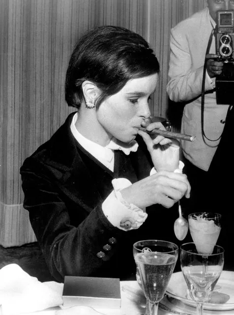 Actress Geraldine Chaplin smokes a cigar at a table during the Cannes Film Festival, May 2, 1967, in France. (Photo by RDA/Hulton Archive/Getty Images)