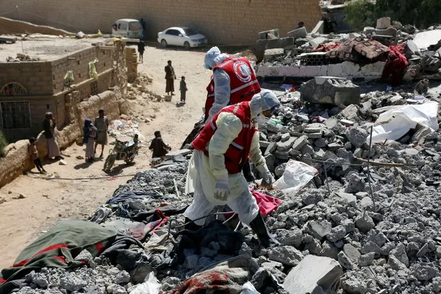 Rescue members search for victims among rubble from over victims struck by aerial attacks carried out by jet crafts of the coalition led by Saudi Arabia targeting a prison in the Houthi strong-hold Saadah Province, on January 22, 2022 in Saadah, Yemen. Aerial attacks carried out by jet crafts of the coalition led by Saudi Arabia targeted a prison leaving at least 90 prisoners killed and over 100 others injured. (Photo by Mohammed Hamoud/Getty Images)