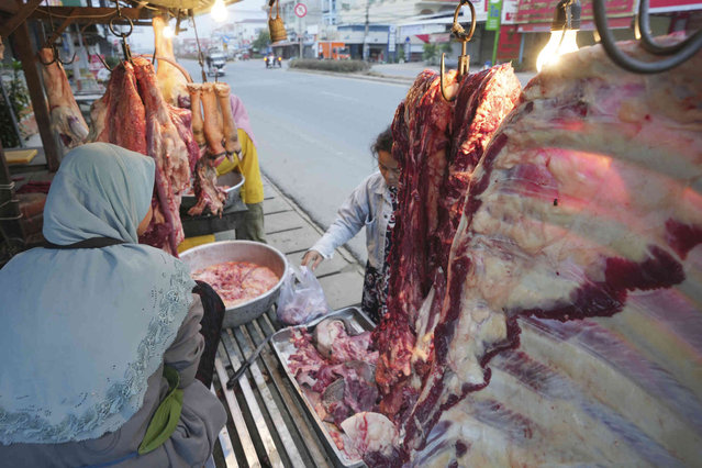 A Cambodian Muslim vendor, left, sells fresh beefs at the outskirts of Phnom Penh Cambodia, on Saturday morning, May 11, 2024. (Photo by Heng Sinith/AP Photo)