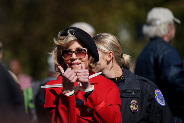 Actor and activist Jane Fonda gives a thumbs up in handcuffs as she is detained for blocking the street in front of the Library of Congress during the “Fire Drill Fridays” protest in Washington, U.S., October 18, 2019. (Photo by Sarah Silbiger/Reuters)