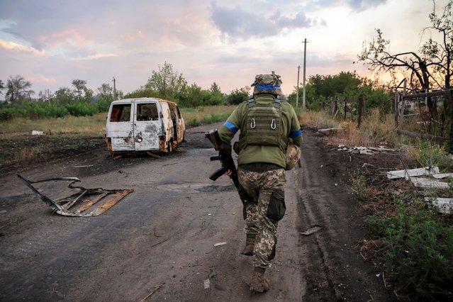 A serviceman of 24th Mechanized brigade runs on the street at a front line near the town of Chasiv Yar in Donetsk region, Ukraine on August 7, 2024. (Photo by Oleg Petrasiuk/Press Service of the Ukrainian Armed Forces)