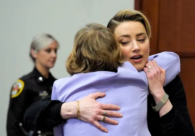 Actress Amber Heard hugs her attorney as she arrives in the courtroom at the Fairfax County Circuit Courthouse in Fairfax, Virginia, April 25, 2022. Actor Johnny Depp sued his ex-wife Amber Heard for libel in Fairfax County Circuit Court after she wrote an op-ed piece in The Washington Post in 2018 referring to herself as a “public figure representing domestic abuse”. (Photo by Steve Helber/Pool via AFP Photo)