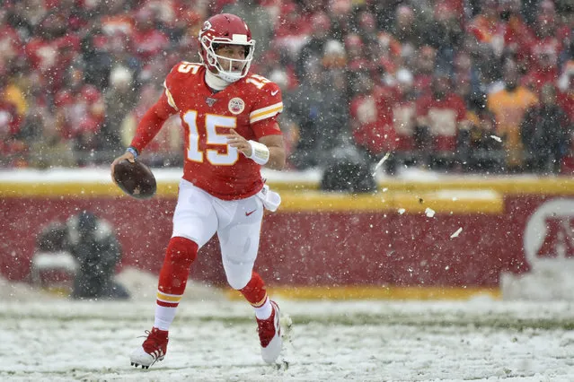 Kansas City Chiefs quarterback Patrick Mahomes (15) carries the ball during the first half of an NFL football game against the Denver Broncos in Kansas City, Mo., Sunday, December 15, 2019. (Photo by Ed Zurga/AP Photo)