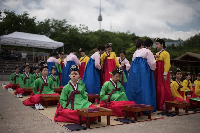 South Korean students attend a traditional coming-of-age ceremony at Namsan hanok village in Seoul on May 15, 2017. The ceremony marks the age of 19, at which a person is legally able to make life choices from voting, to drinking alcohol. (Photo by Ed Jones/AFP Photo)