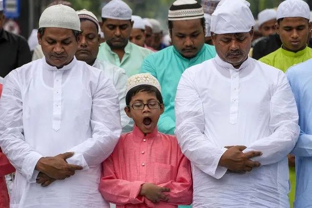 A Muslim boy yawns as he offers prayers with others on Eid al-fitr in Kolkata, India, Tuesday, May 3, 2022. Muslims make 14 percent of India's 1.4 billion population and are the largest minority group in the Hindu-majority nation. (Photo by Bikas Das/AP Photo)