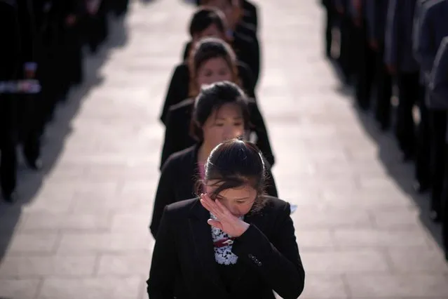 A woman wiper her eyes as she waits to pay her respects before the statues of late North Korean leaders Kim Il Sung and Kim Jong Il, as part of celebrations marking the anniversary of the birth of Kim Il Sung, known as the “Day of the Sun”, on Mansu hill in Pyongyang on April 15, 2019. (Photo by Ed Jones/AFP Photo)