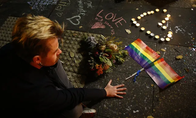 A man attends a candlelight vigil for the victims of the Pulse Nightclub shooting in Orlando, Florida, at Newtown Neighbourhood Centre on June 13, 2016 in Sydney, Australia. 50 people were killed and 53 injured after a gunman opened fire on people in a gay nightclub in Florida. It is the deadliest mass shooting in US history. (Photo by Daniel Munoz/Getty Images)