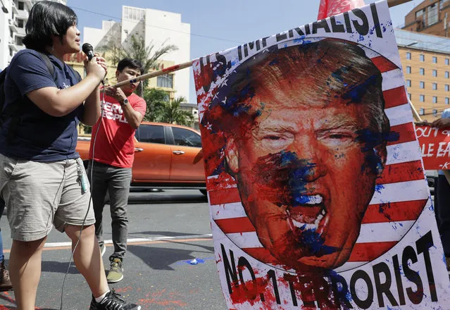 A protester shouts slogans with an image of U.S. President Donald Trump during a rally opposing the recent U.S. attack that killed Iranian Gen. Qassem Soleimani in Manila, Philippines Monday January 6, 2020. Philippine President Rodrigo Duterte has ordered the military to prepare to deploy its aircraft and ships “at any moment's notice” to evacuate thousands of Filipino workers in Iraq and Iran should hostilities erupt there. (Photo by Aaron Favila/AP Photo)