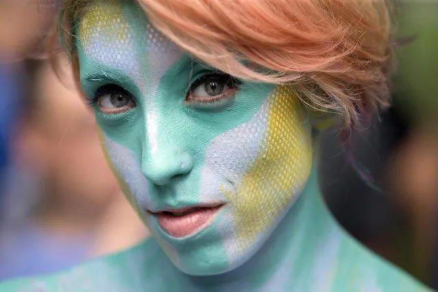 Desiree Urban is painted at Columbus Circle as body-painting artists gathered to decorate nude models as part of an event featuring artist Andy Golub, Saturday, July 26, 2014, in New York. Golub says New York was the only city in the country that would allow his inaugural Bodypainting Day. (Photo by John Minchillo/AP Photo)