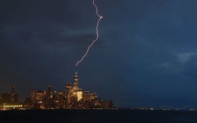 A lightning bolt strikes One World Trade Center as a thunderstorm passes over lower Manhattan in New York City on June 26, 2024, as seen from Hoboken, New Jersey. (Photo by Gary Hershorn/Getty Images)