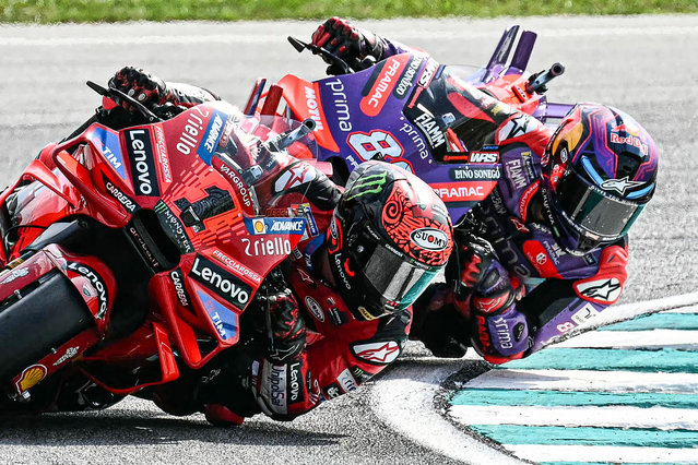 Ducati Lenovo Team's Italian rider Francesco Bagnaia (L) and Prima Pramac Racing's Spanish rider Jorge Martin compete during the MotoGP Malaysian Grand Prix at the Sepang International Circuit in Sepang on November 3, 2024. (Photo by Mohd Rasfan/AFP Photo)
