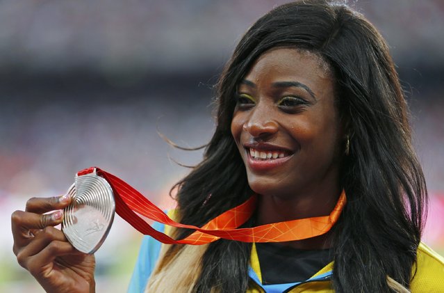 Shaunae Miller of Bahamas presents her silver medal as she poses on the podium after the women's 400m event during the 15th IAAF World Championships at the National Stadium in Beijing, China, August 28, 2015. (Photo by Damir Sagolj/Reuters)
